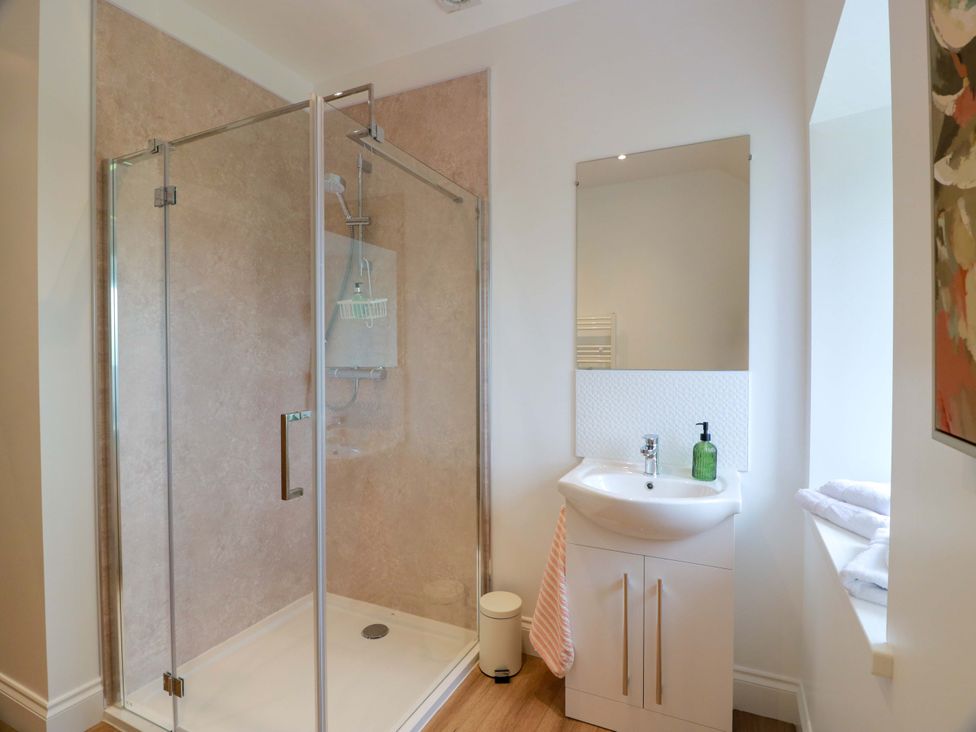 A bathroom with a shower and sink at Burnside Bothy near Girvan