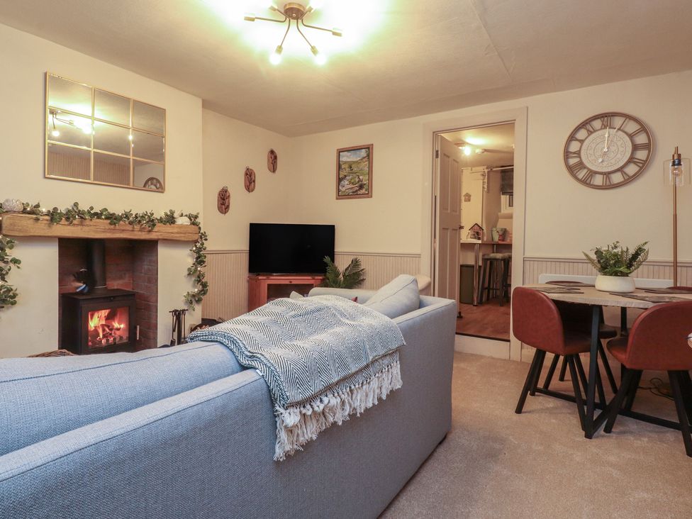 A living room with a fireplace and sofa at Willow Wood in Settle