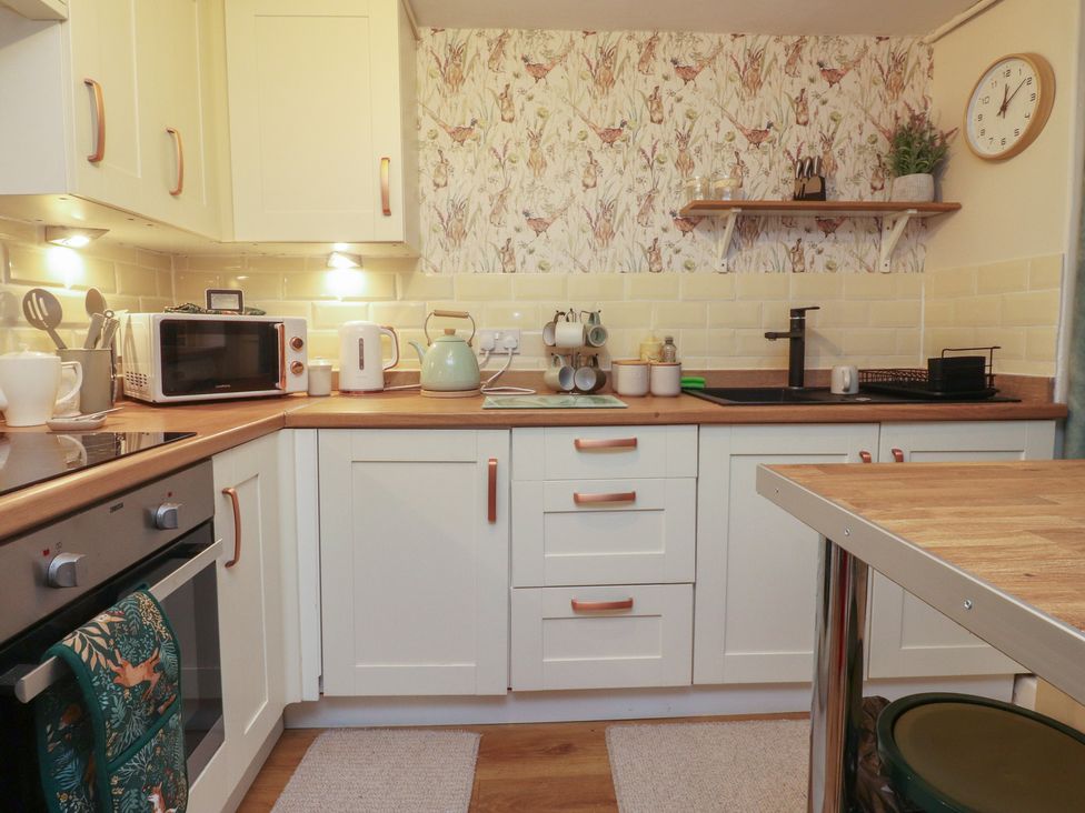 A kitchen with a kettle and sink at Willow Wood in Settle