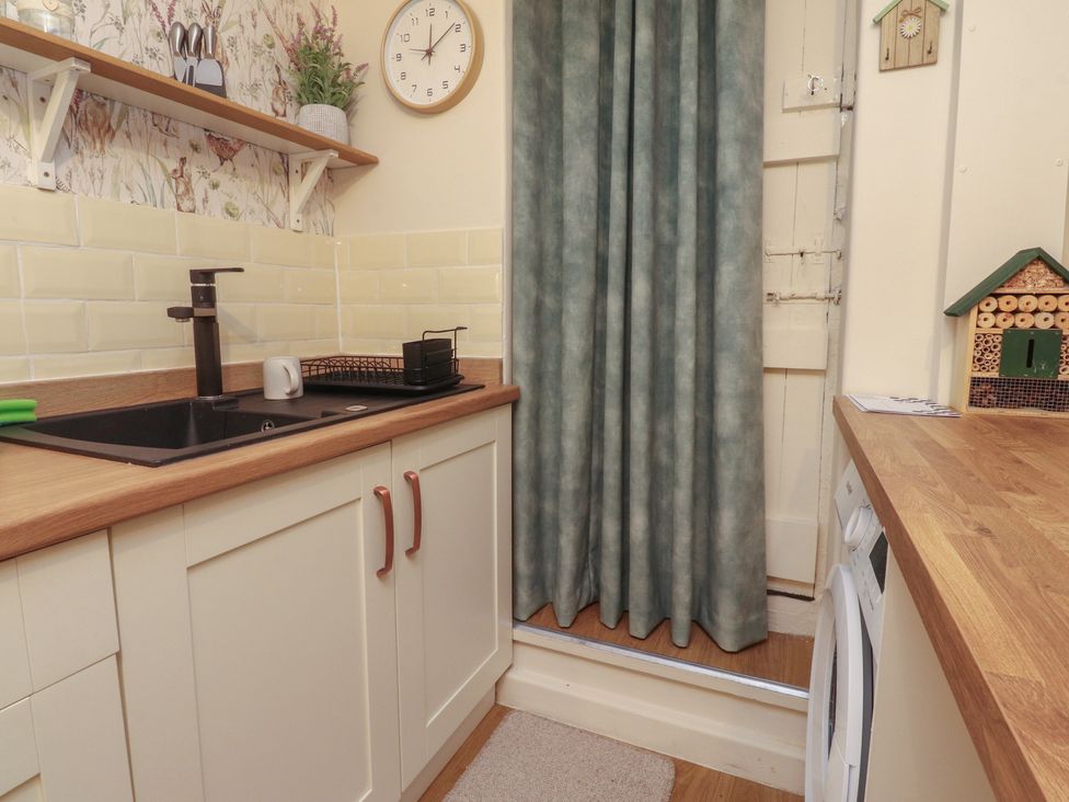 A kitchen with sink and cabinets at Willow Wood in Settle