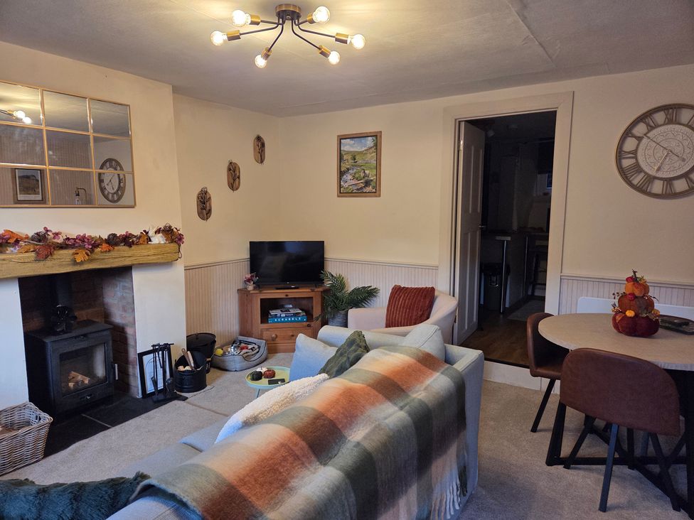 A living room with a sofa and television at Willow Wood in Langcliffe near Settle