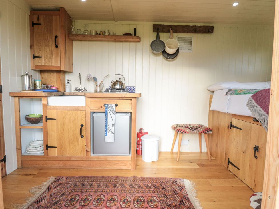 A kitchen with storage and appliances at Honeysuckle Hut, Potto Grange Farm, Northallerton