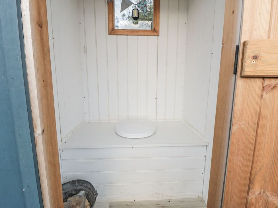 A bathroom with a toilet and a window at Honeysuckle Hut, Potto Grange Farm Northallerton
