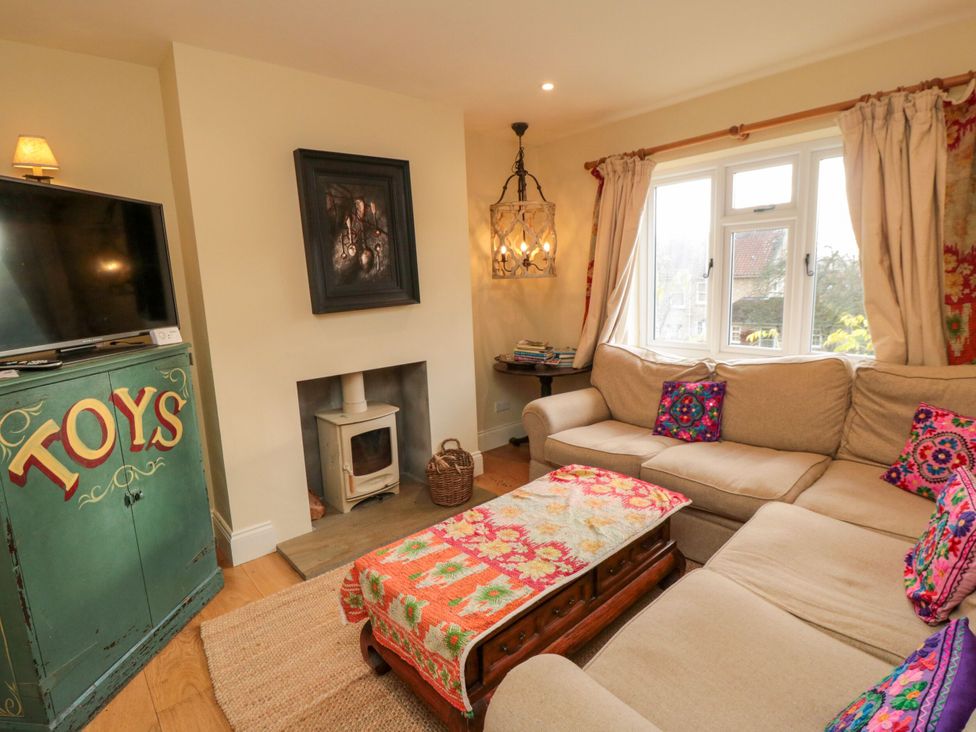 A living room with a television and a sofa at St. Anthonys in York