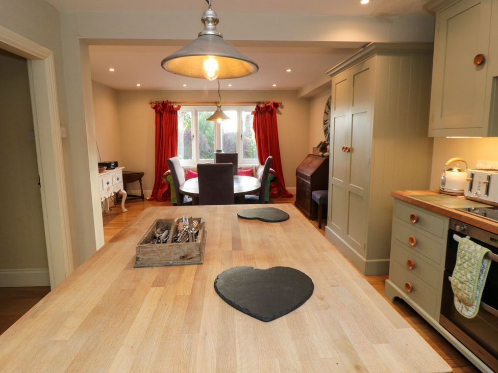 A kitchen with an island, table, and chairs at St. Anthonys in York