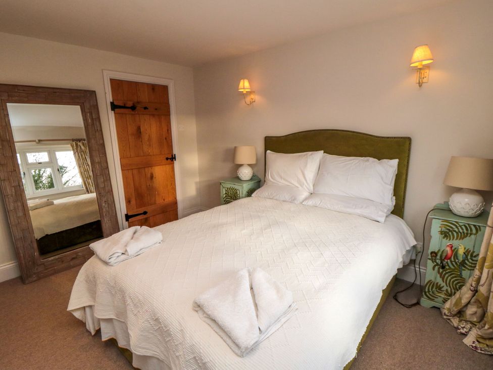 A bedroom with a bed and nightstands at St. Anthonys in York