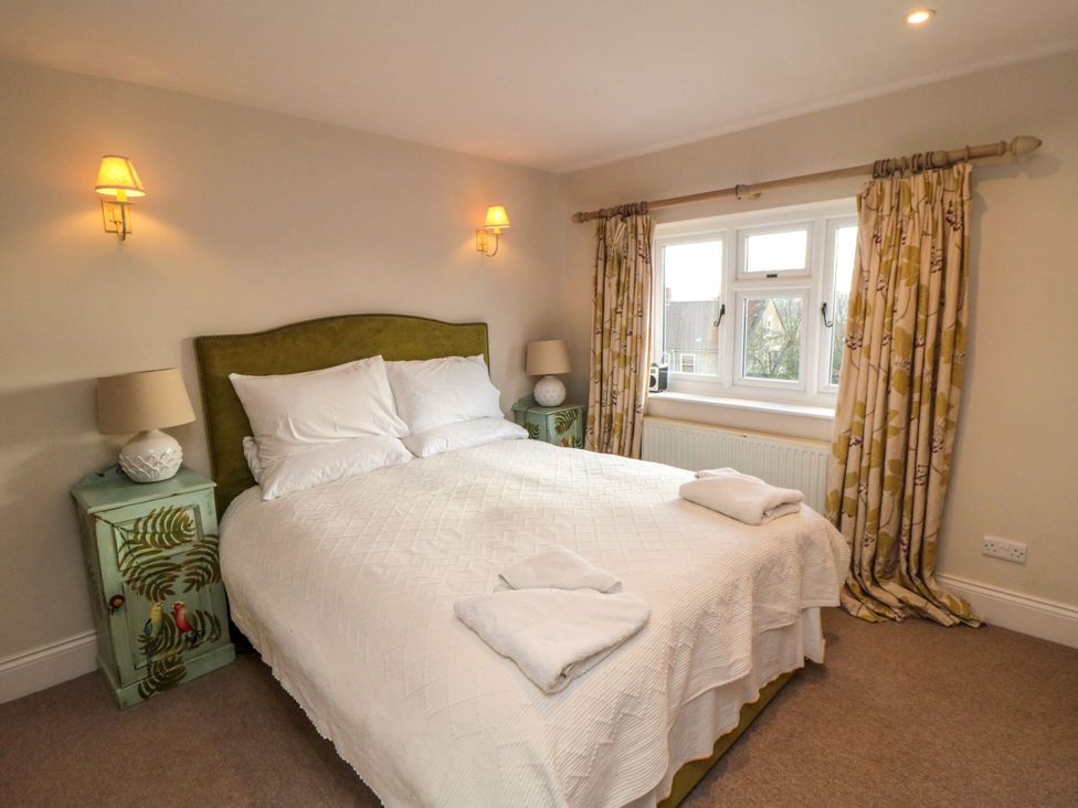 A bedroom with a bed and side tables at St. Anthonys in York