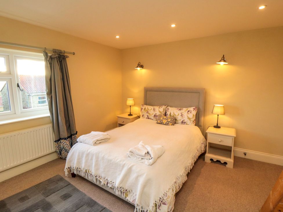 A bedroom with a bed and bedside tables at St. Anthonys in York