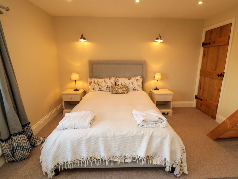 A bedroom with a bed and bedside tables at St. Anthonys in York