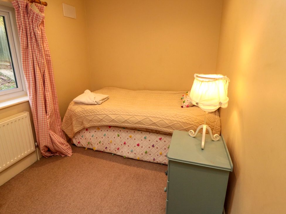 A bedroom with a bed and lamp at St. Anthonys in York