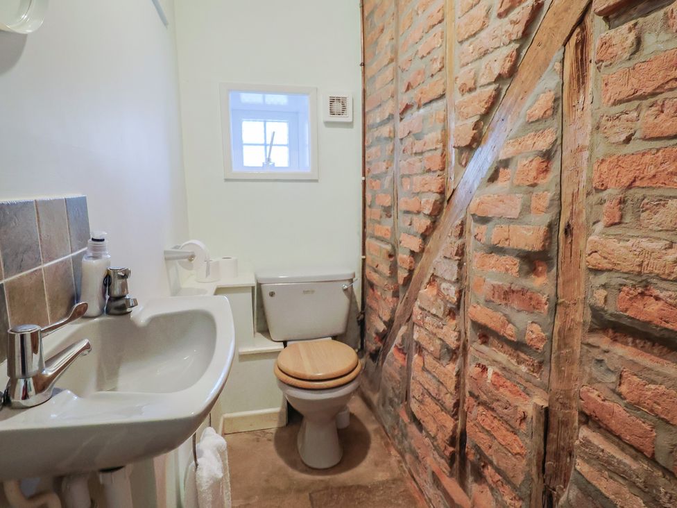 A bathroom with a sink and a toilet at Goulds Farmhouse Milborne St Andrew
