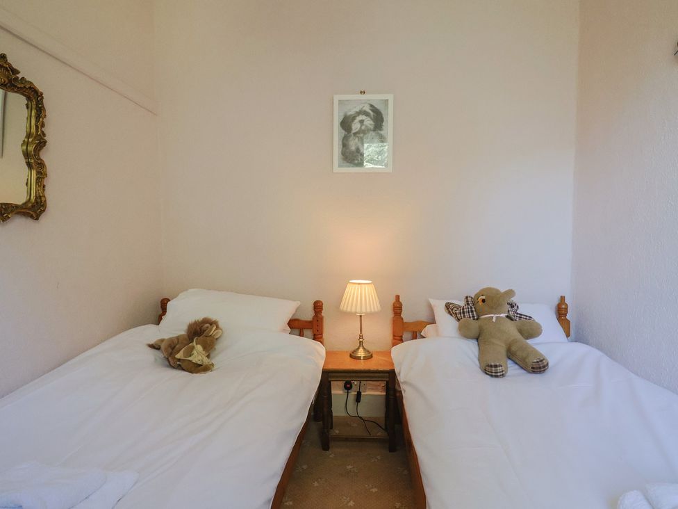 A bedroom with twin beds and stuffed animals at Goulds Farmhouse in Milborne St Andrew