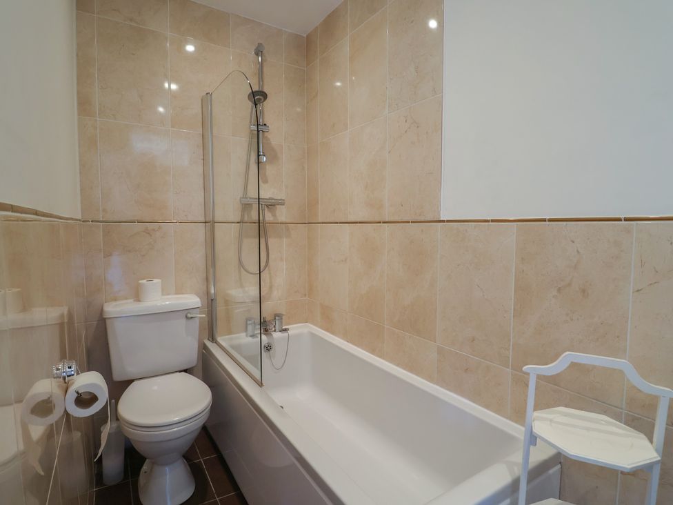 A bathroom with a bathtub and toilet at Goulds Farmhouse in Milborne St Andrew