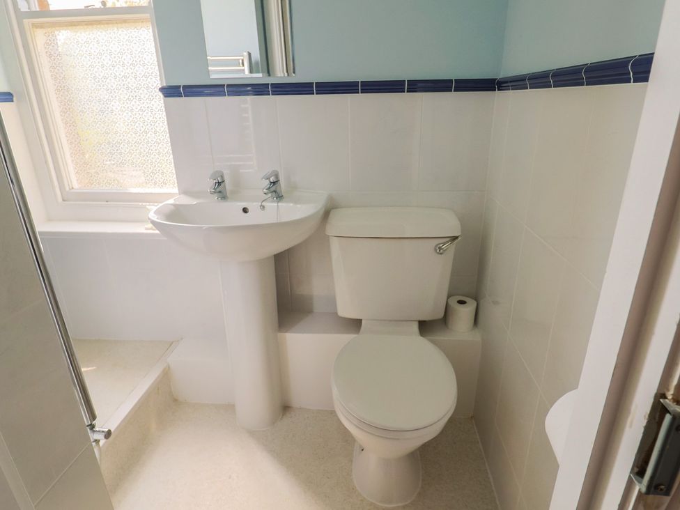 A bathroom with a sink and toilet at Goulds Farmhouse in Milborne St Andrew