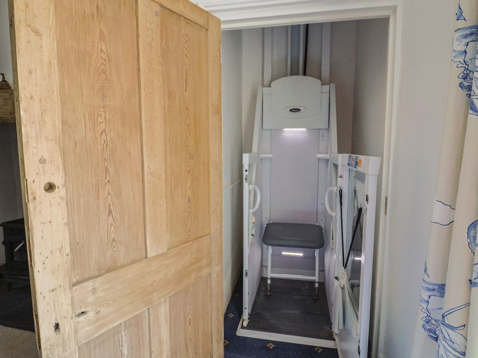 A stair lift next to a door at Goulds Farmhouse in Milborne St Andrew