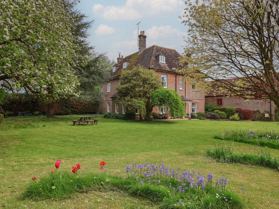 A house with a garden and trees at Goulds Farmhouse Milborne St Andrew