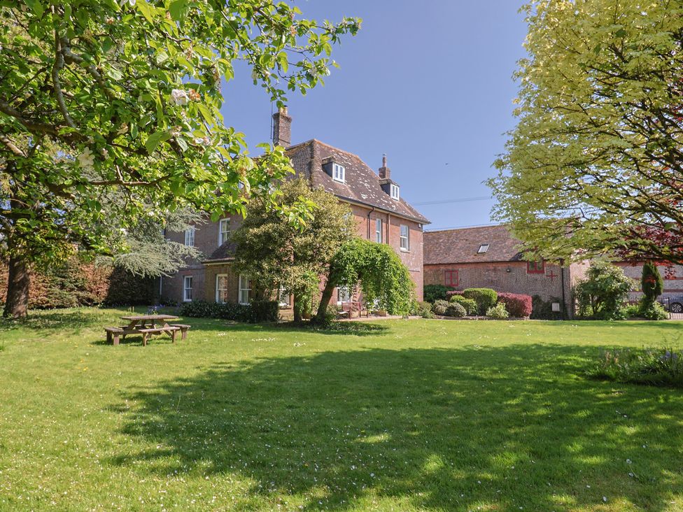 A house with a garden and trees at Goulds Farmhouse in Milborne St Andrew