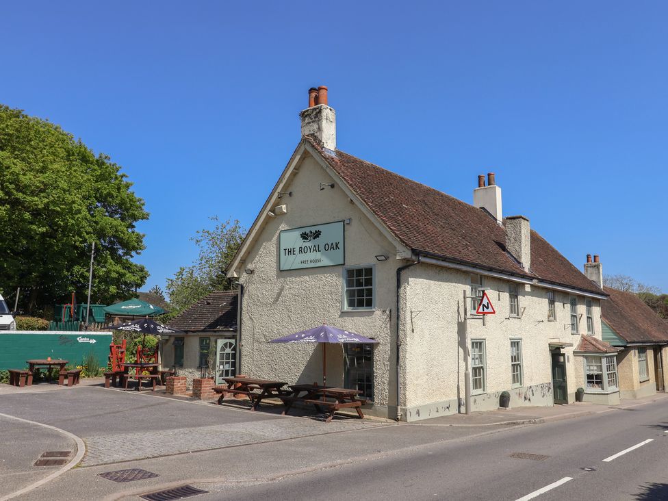 A pub exterior with outdoor seating at The Royal Oak in Milborne St Andrew