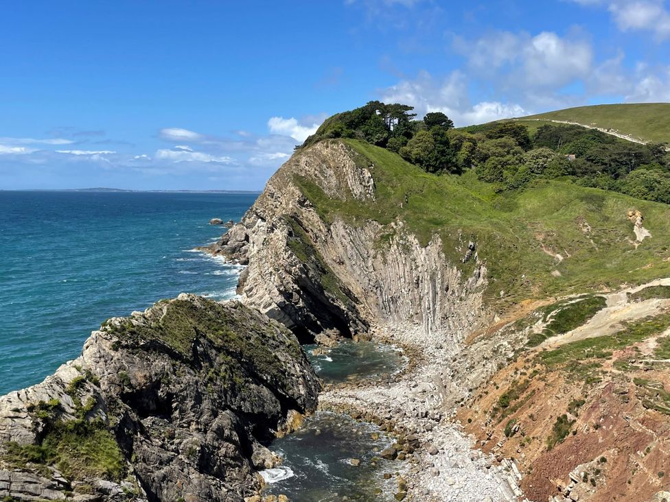 A coastal view with cliffs and ocean at Goulds Farmhouse Milborne St Andrew