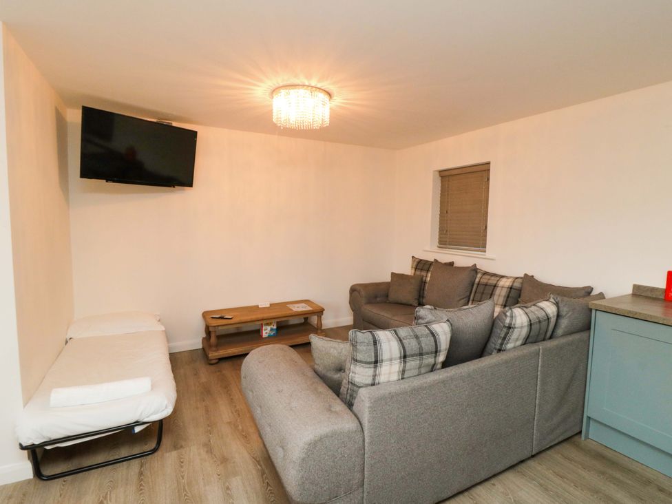 A living room with a sofa and television at Tooth Suite Yarm
