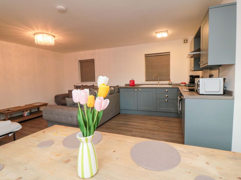 A kitchen with a dining table and sofa at Tooth Suite in Yarm