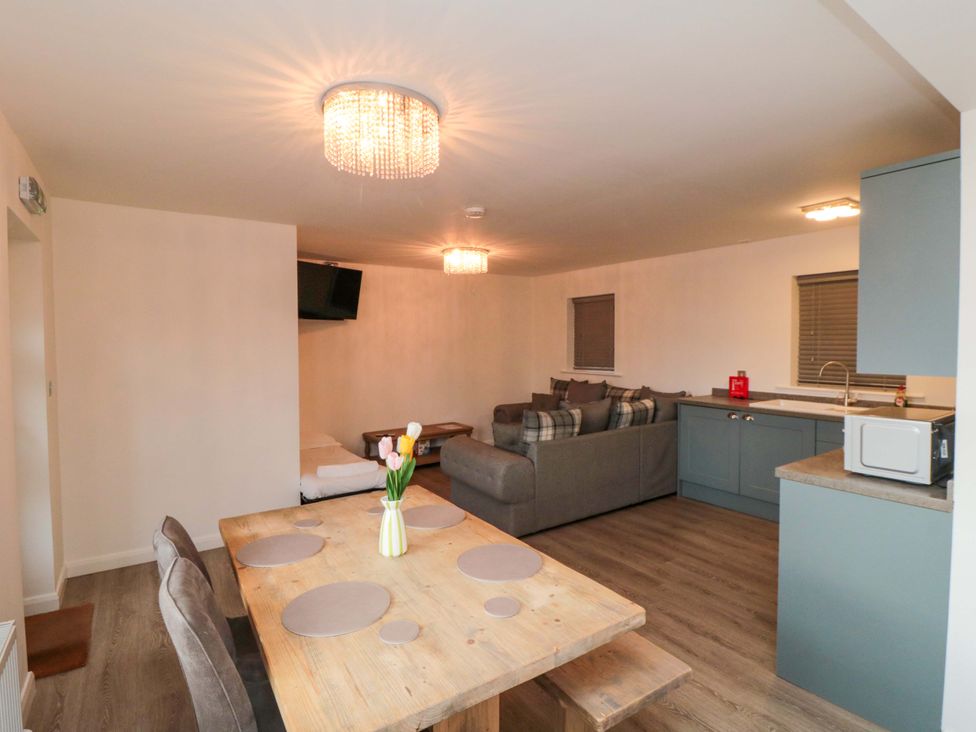 A living room with a dining table and sofa at Tooth Suite in Yarm