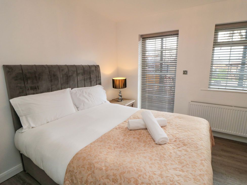 A bedroom with a bed and bedside table at Tooth Suite Yarm
