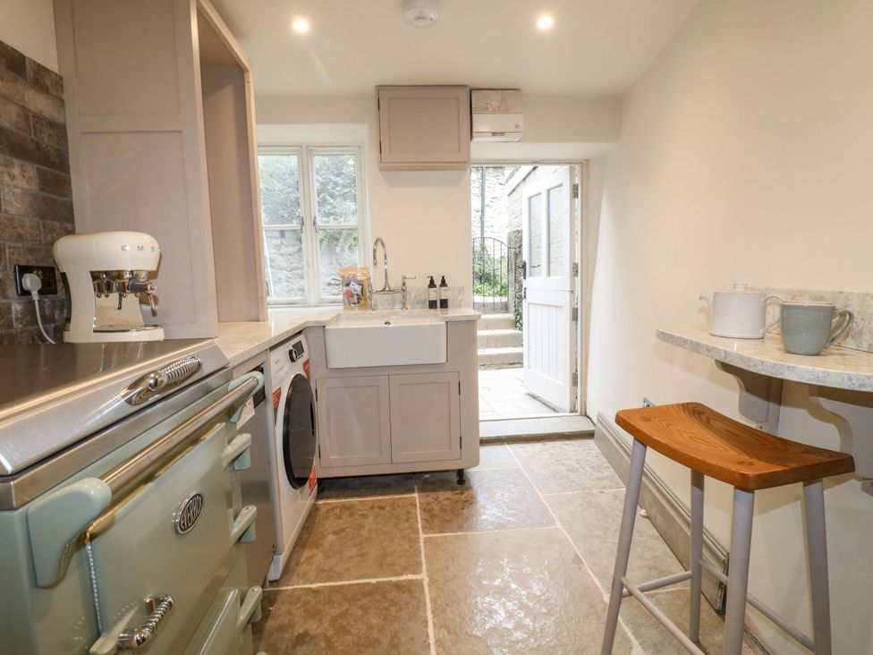 A kitchen with a sink and washing machine at Hope Cottage in Great Longstone