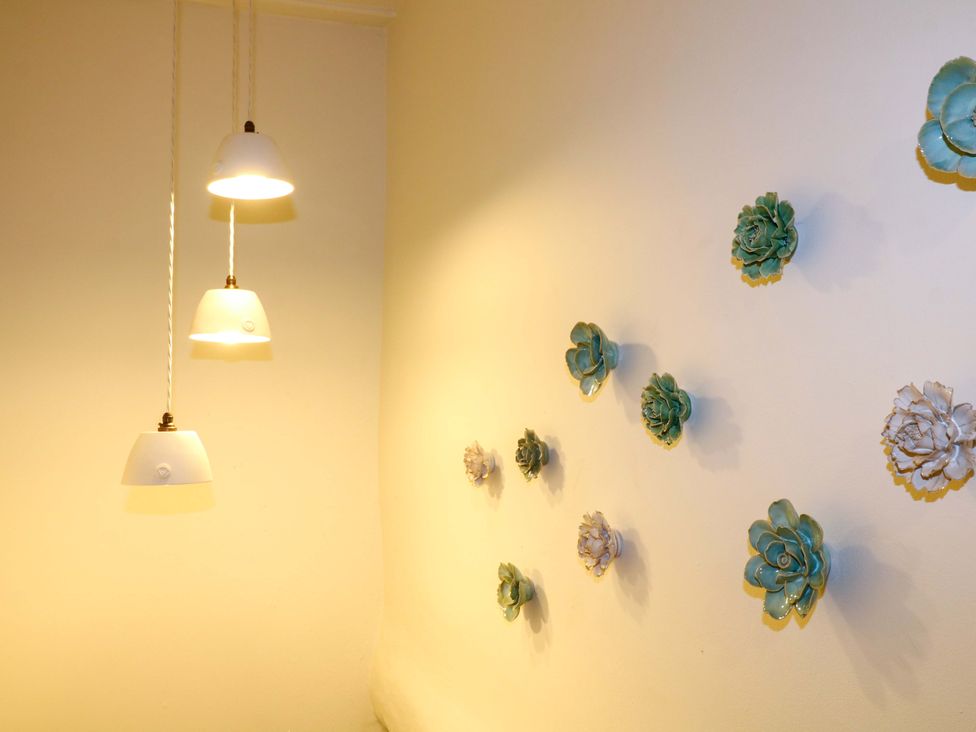 Light fixtures and decorative wall art at Hope Cottage in Great Longstone