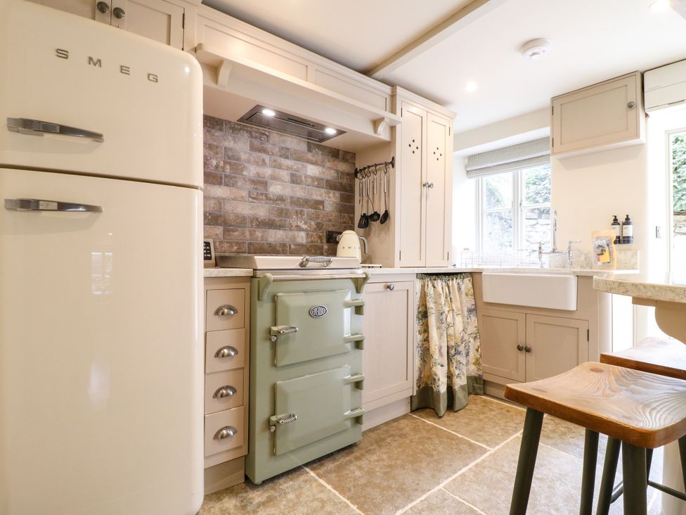 A kitchen with a refrigerator and oven at Hope Cottage in Great Longstone
