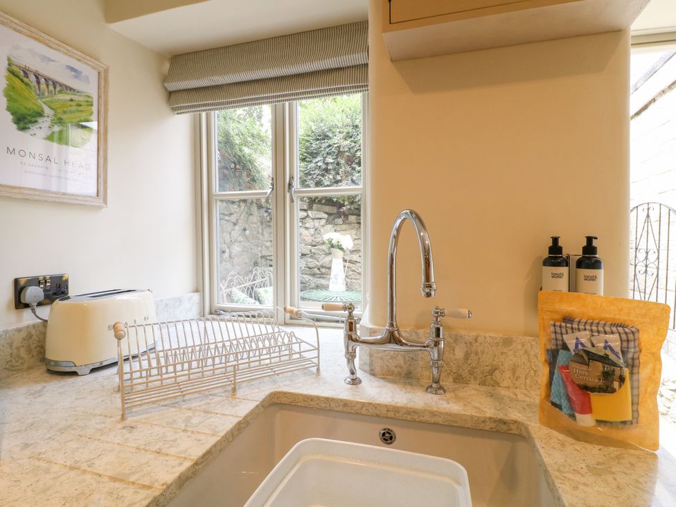 A kitchen with a sink and faucet at Hope Cottage in Great Longstone