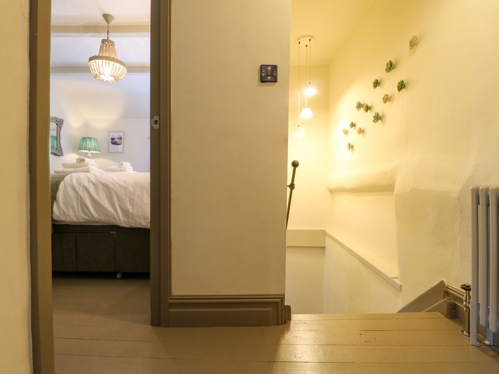 A hallway with a view of a bedroom at Hope Cottage in Great Longstone