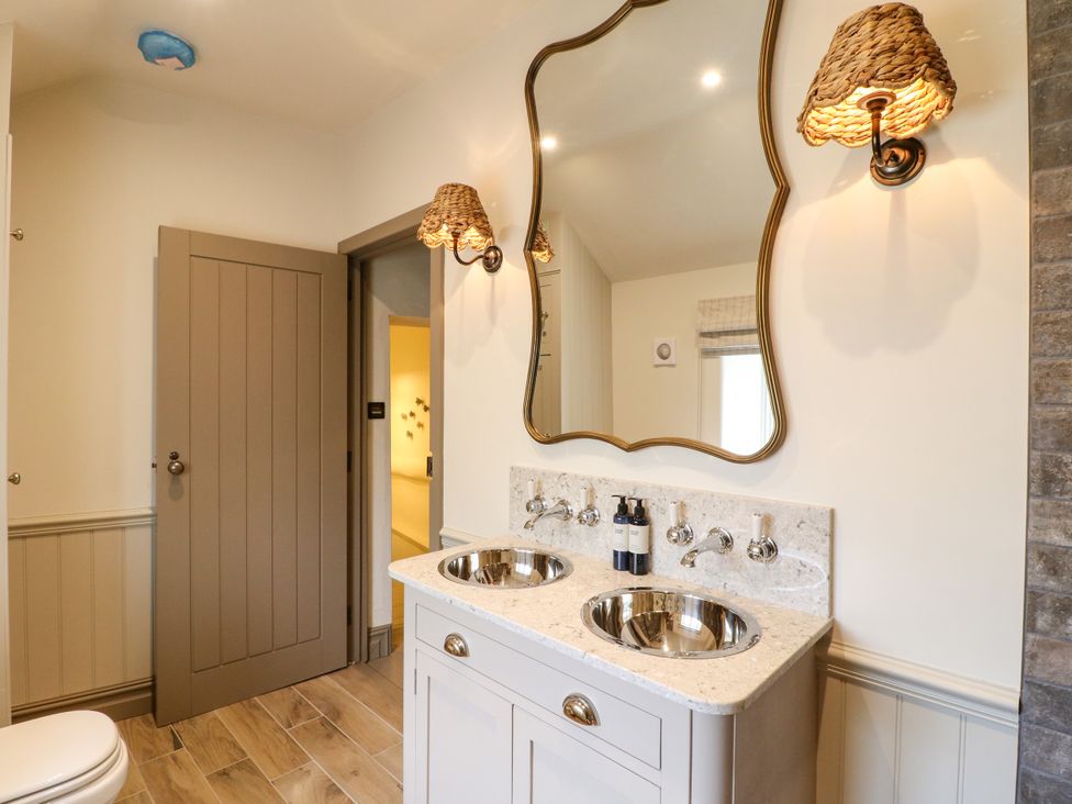 A bathroom with dual sinks and a mirror at Hope Cottage in Great Longstone