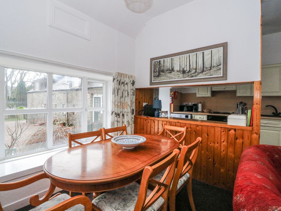 A dining room with a table and chairs at Oak Killean Farmhouse Cottages near Inveraray