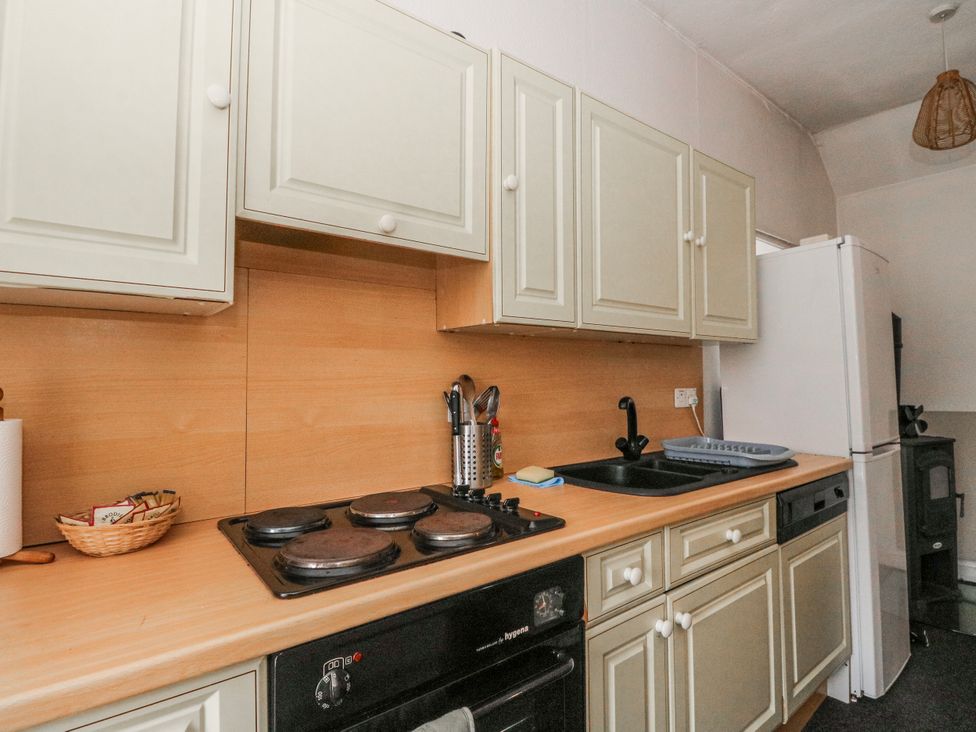 A kitchen featuring cabinets, a cooking hob, sink, and refrigerator at Oak near Killean Farmhouse Cottages near Inveraray