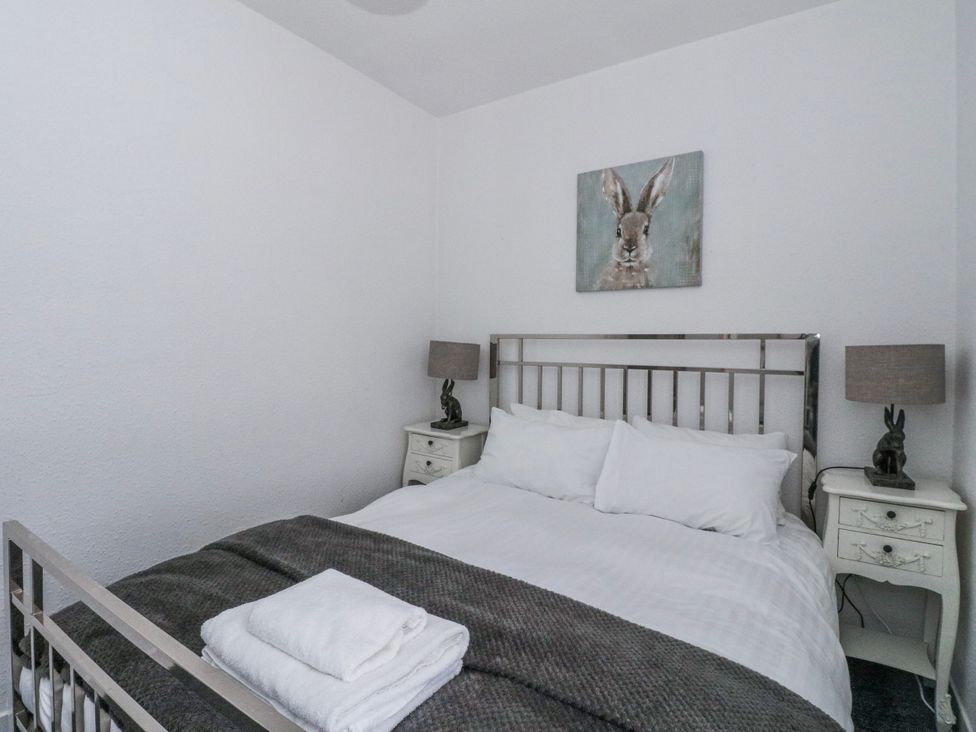 A bedroom with a bed and bedside tables at Oak near Killean Farmhouse Cottages Inveraray