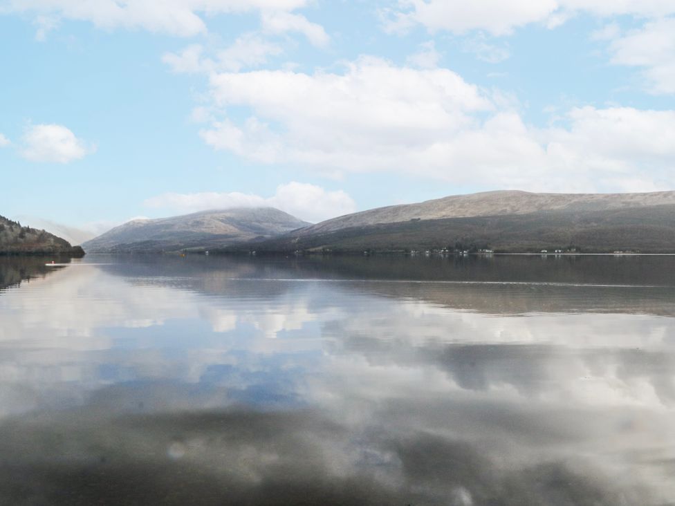 A view of a lake surrounded by mountains at Oak Killean Farmhouse Cottages near Inveraray