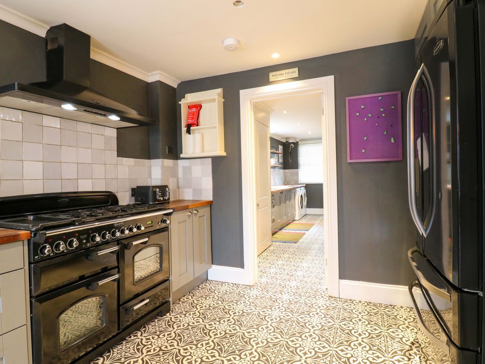 A kitchen with an oven and refrigerator at River Haven in Thames Ditton