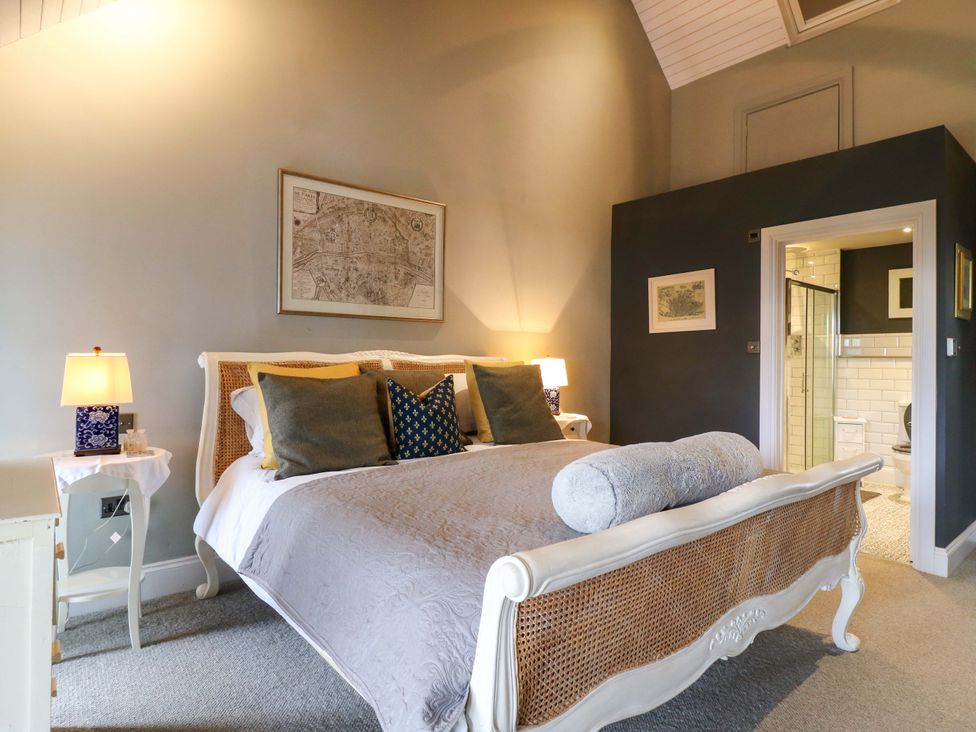 A bedroom with a bed and attached bathroom at River Haven in Thames Ditton