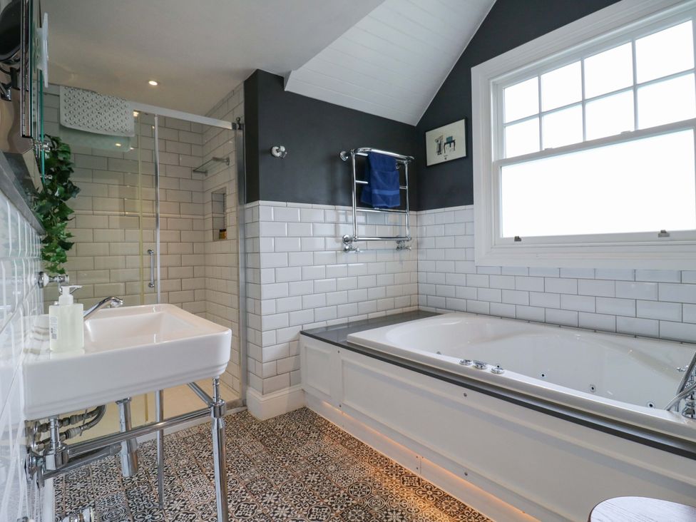 A bathroom with a bathtub and shower at River Haven in Thames Ditton