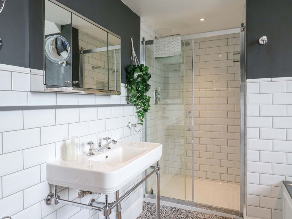 A bathroom with a sink and shower at River Haven in Thames Ditton