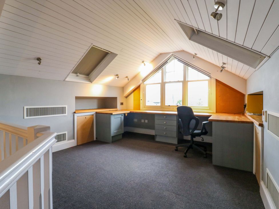 A home office with a desk and chair at River Haven in Thames Ditton