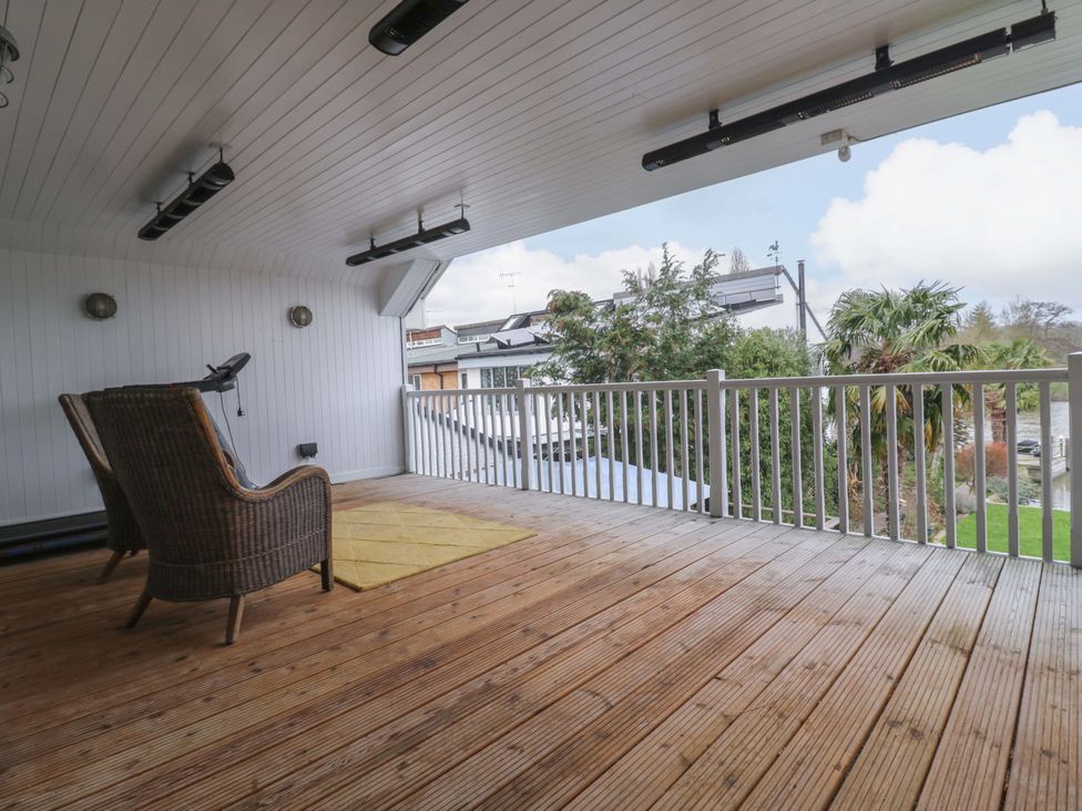 An outdoor space with decking and furniture at River Haven in Thames Ditton
