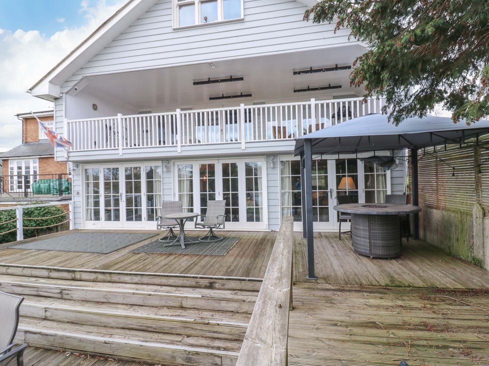 An outdoor area with a deck and outdoor furniture at River Haven in Thames Ditton
