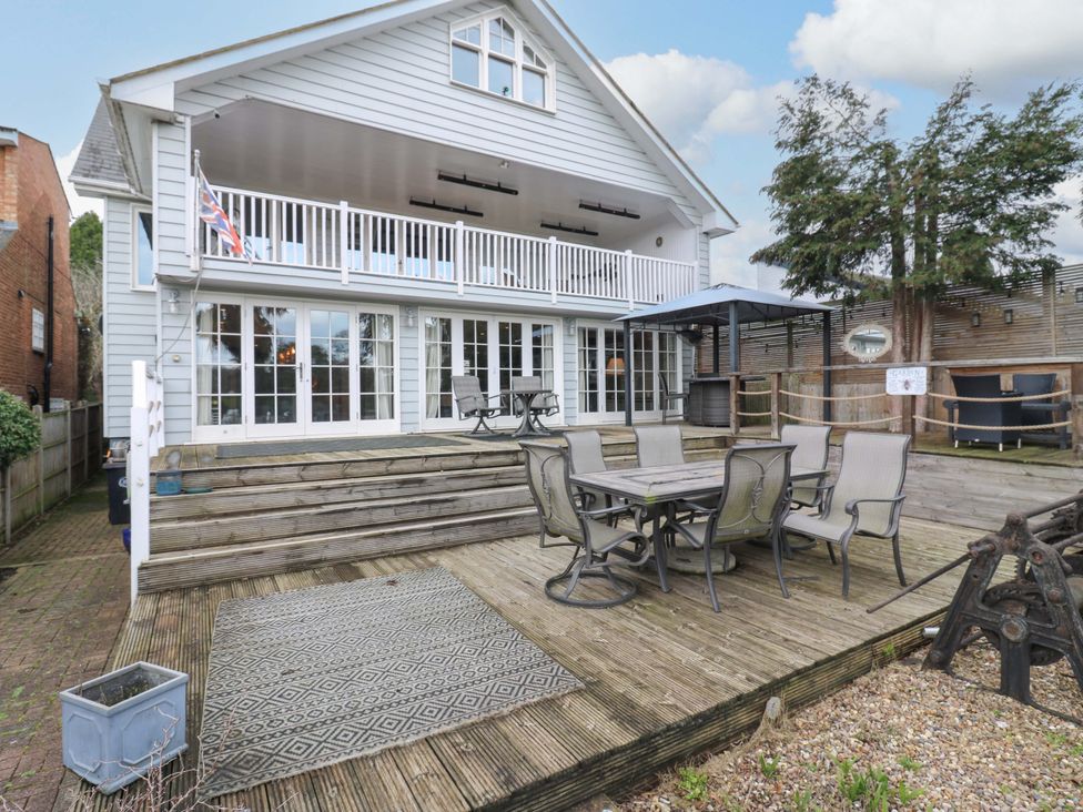 An outdoor dining area with chairs and a table at River Haven in Thames Ditton