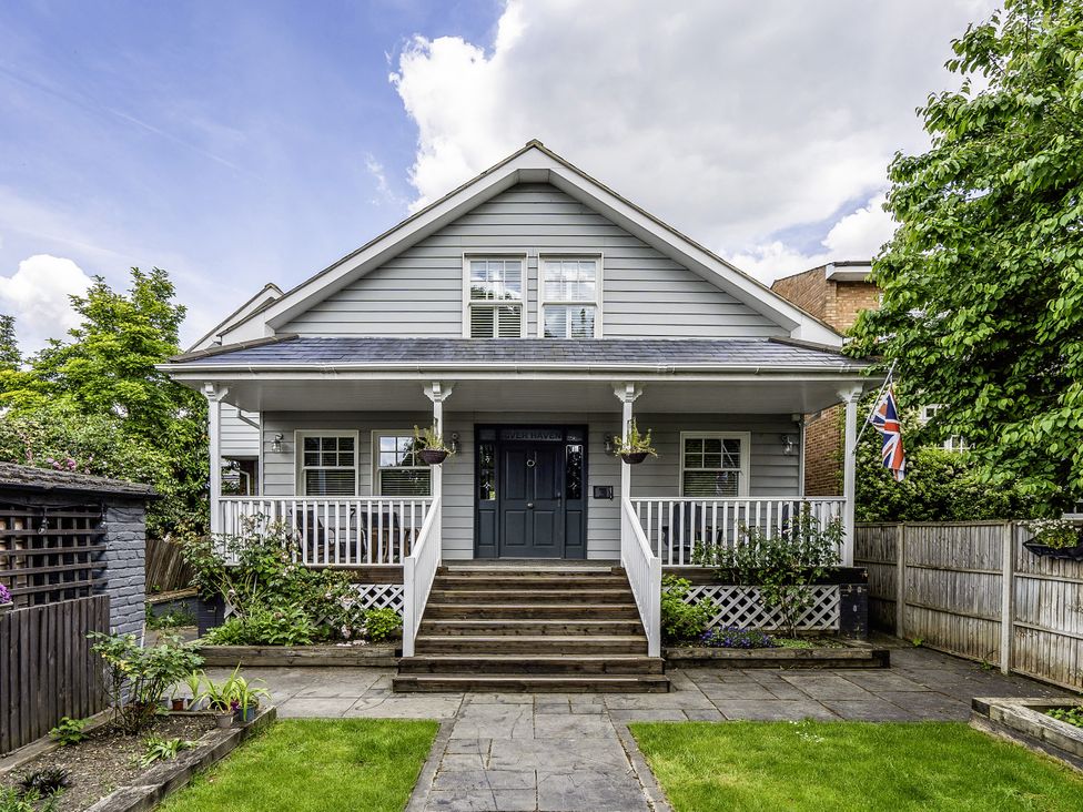 A house with steps leading to the front door at River Haven in Thames Ditton