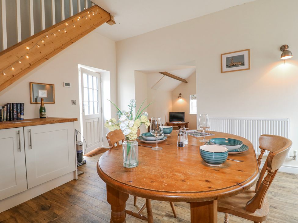 A dining room with a table set for dinner at America Lodge in Oakham