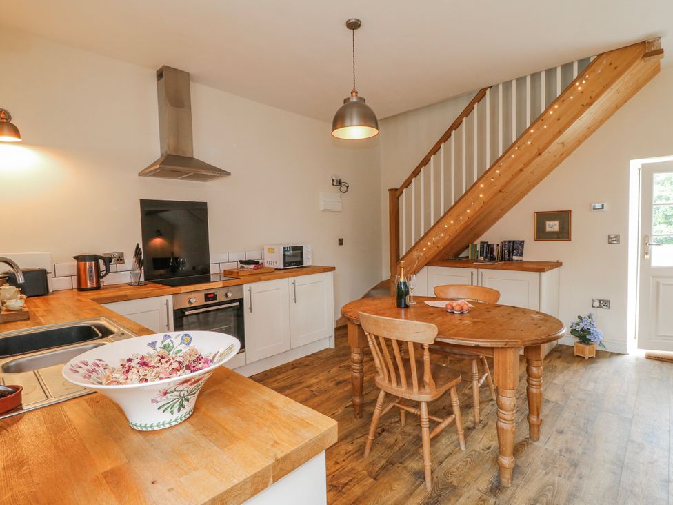 A kitchen with a table and chairs at America Lodge in Oakham