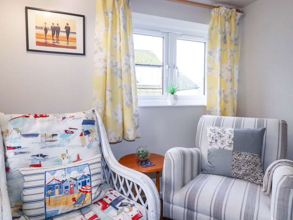 A living room with a couch and a side table at The Penthouse in Looe