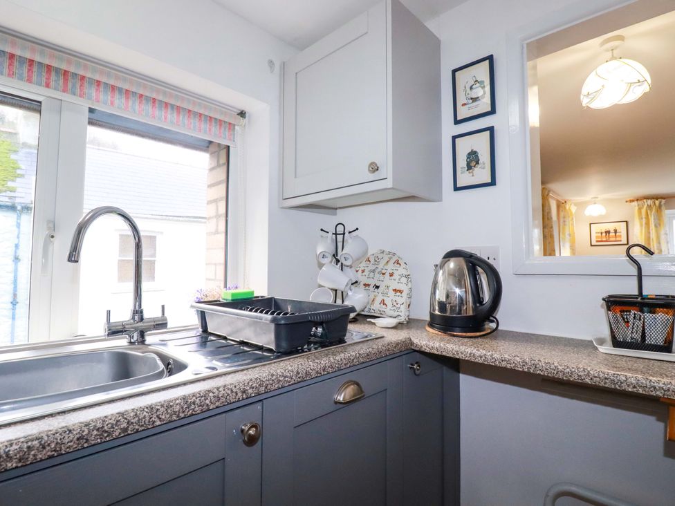 A kitchen with a sink and kettle at The Penthouse in Looe